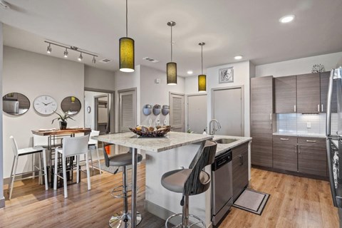 a kitchen with a center island and a table with chairs